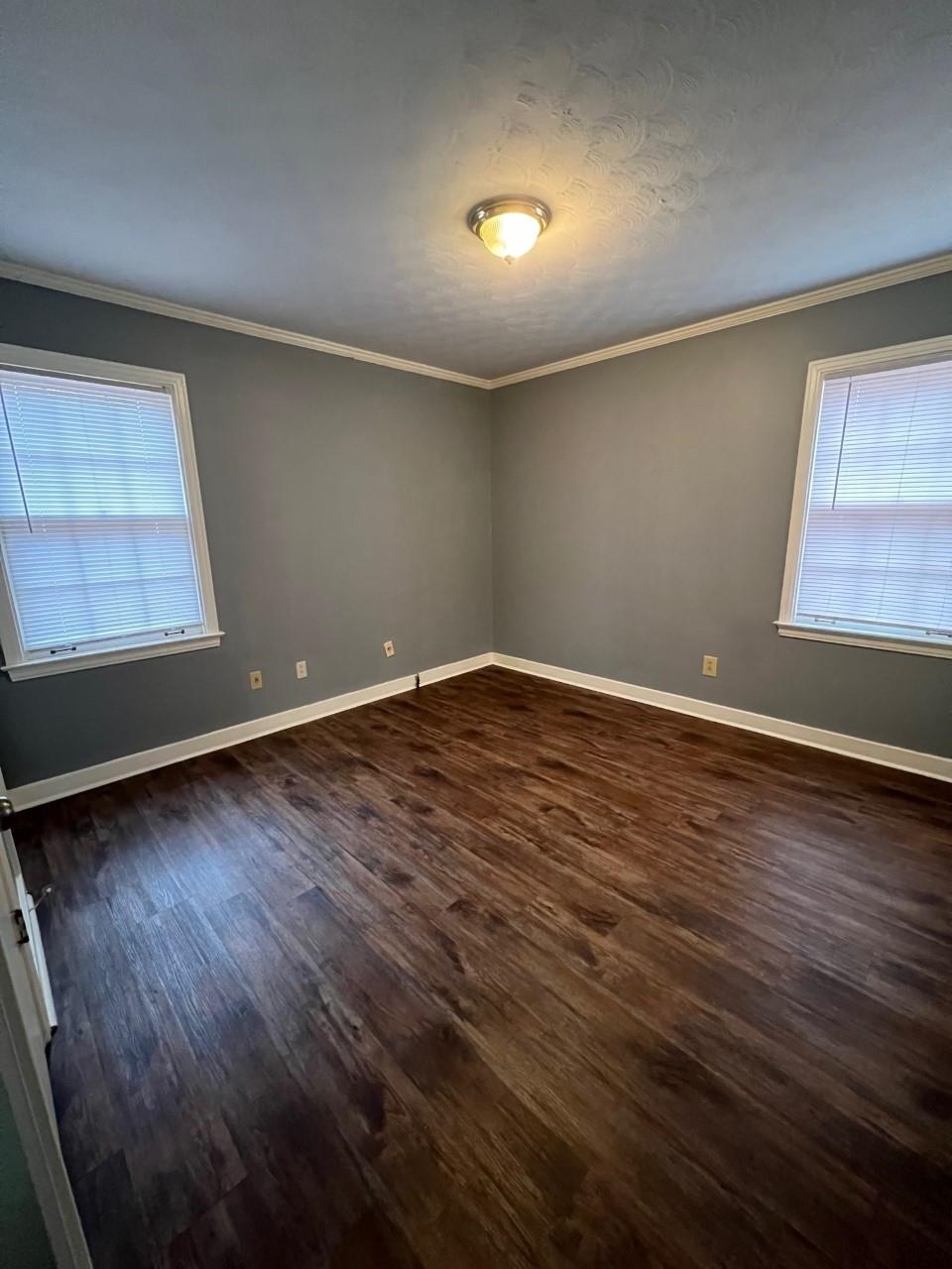 448 North White Station Road Memphis, TN 38120 - Photo 3 of 9 an empty room with wooden floor and windows