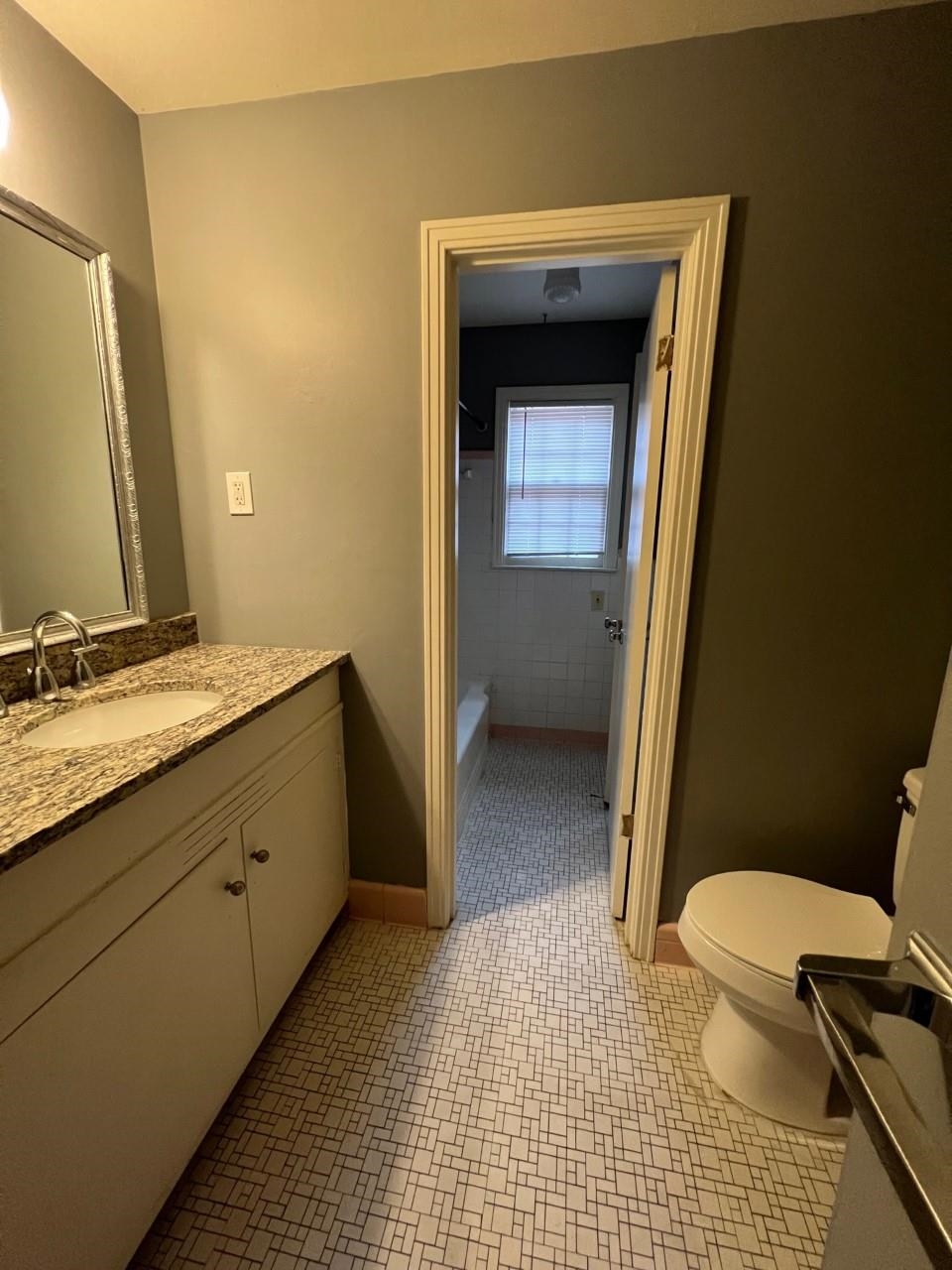 448 North White Station Road Memphis, TN 38120 - Photo 4 of 9 a bathroom with a sink a toilet and a mirror