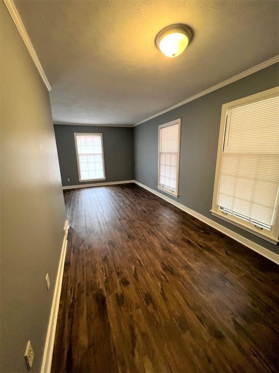 448 North White Station Road Memphis, TN 38120 - Photo 8 of 9 an empty room with wooden floor and windows