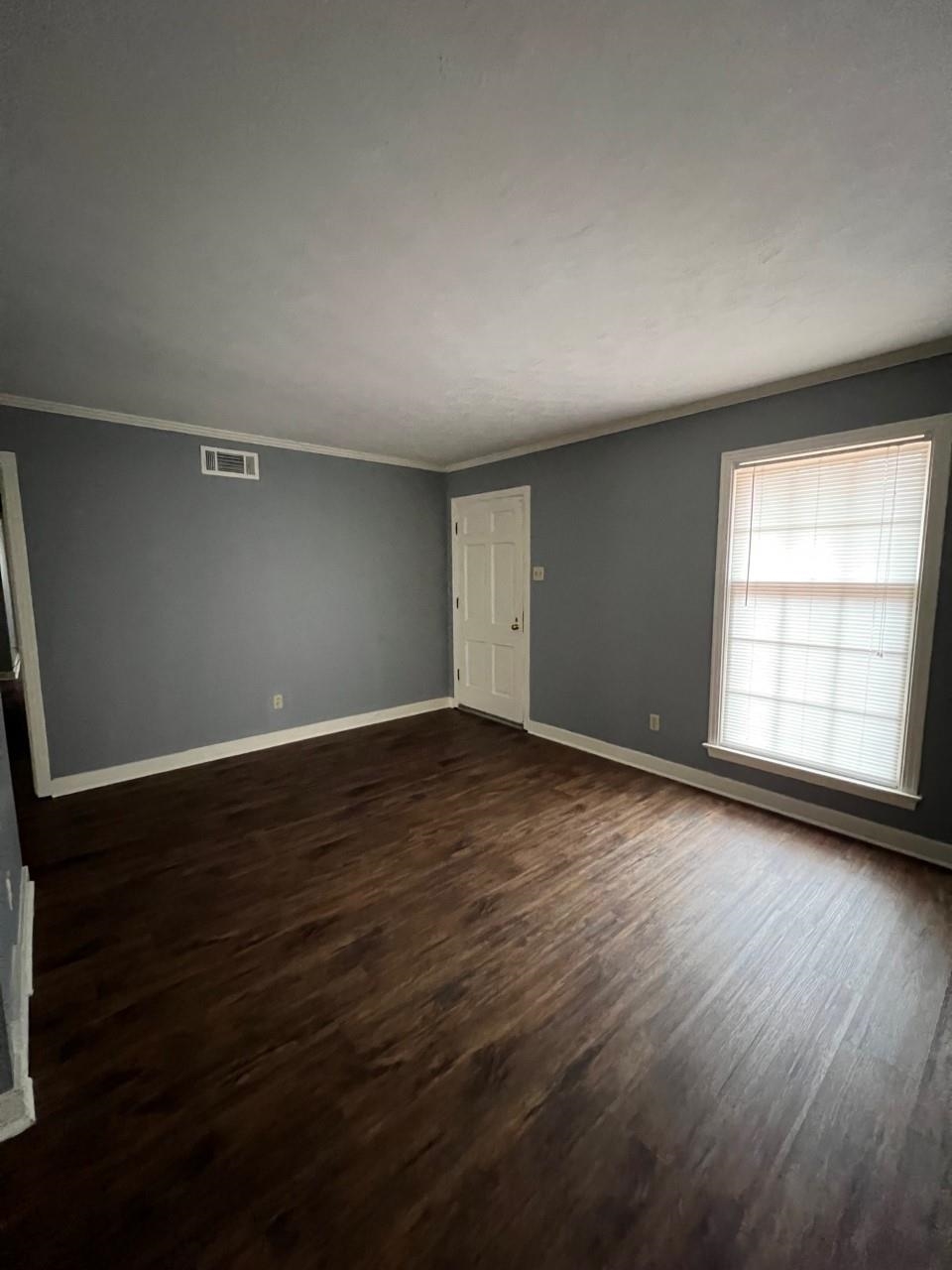 448 North White Station Road Memphis, TN 38120 - Photo 9 of 9 an empty room with wooden floor and windows
