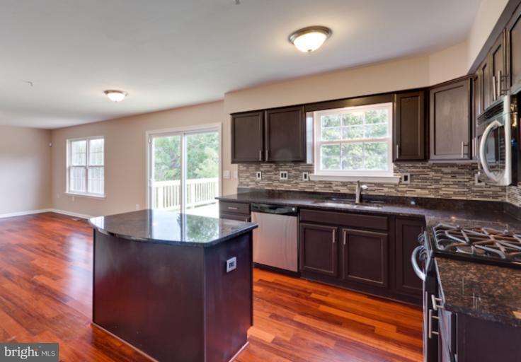 5919 Plata Street Clinton, MD 20735 - Photo 1 of 25 a kitchen with granite countertop a sink stove and cabinets