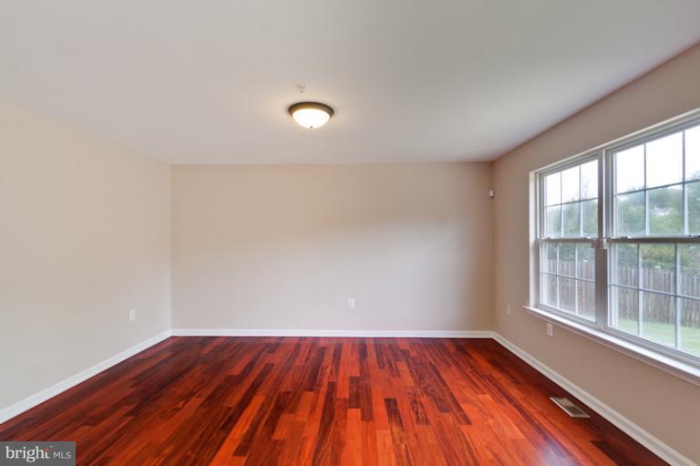 5919 Plata Street Clinton, MD 20735 - Photo 13 of 25 a view of a room with wooden floor and windows