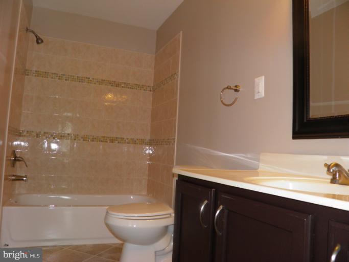 5919 Plata Street Clinton, MD 20735 - Photo 18 of 25 a bathroom with a sink a toilet and shower