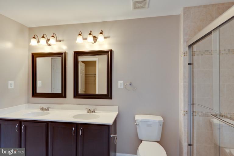 5919 Plata Street Clinton, MD 20735 - Photo 22 of 25 a bathroom with a toilet sink and mirror