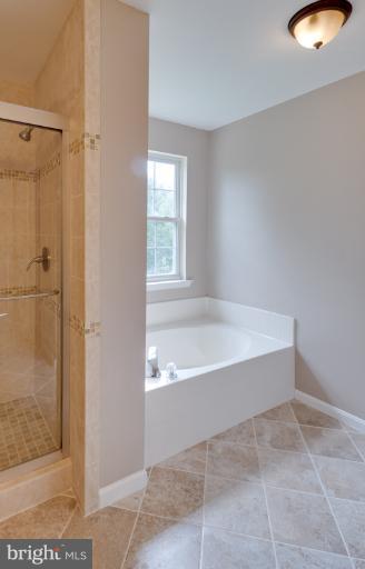 5919 Plata Street Clinton, MD 20735 - Photo 23 of 25 a spacious bathroom with a tub and shower