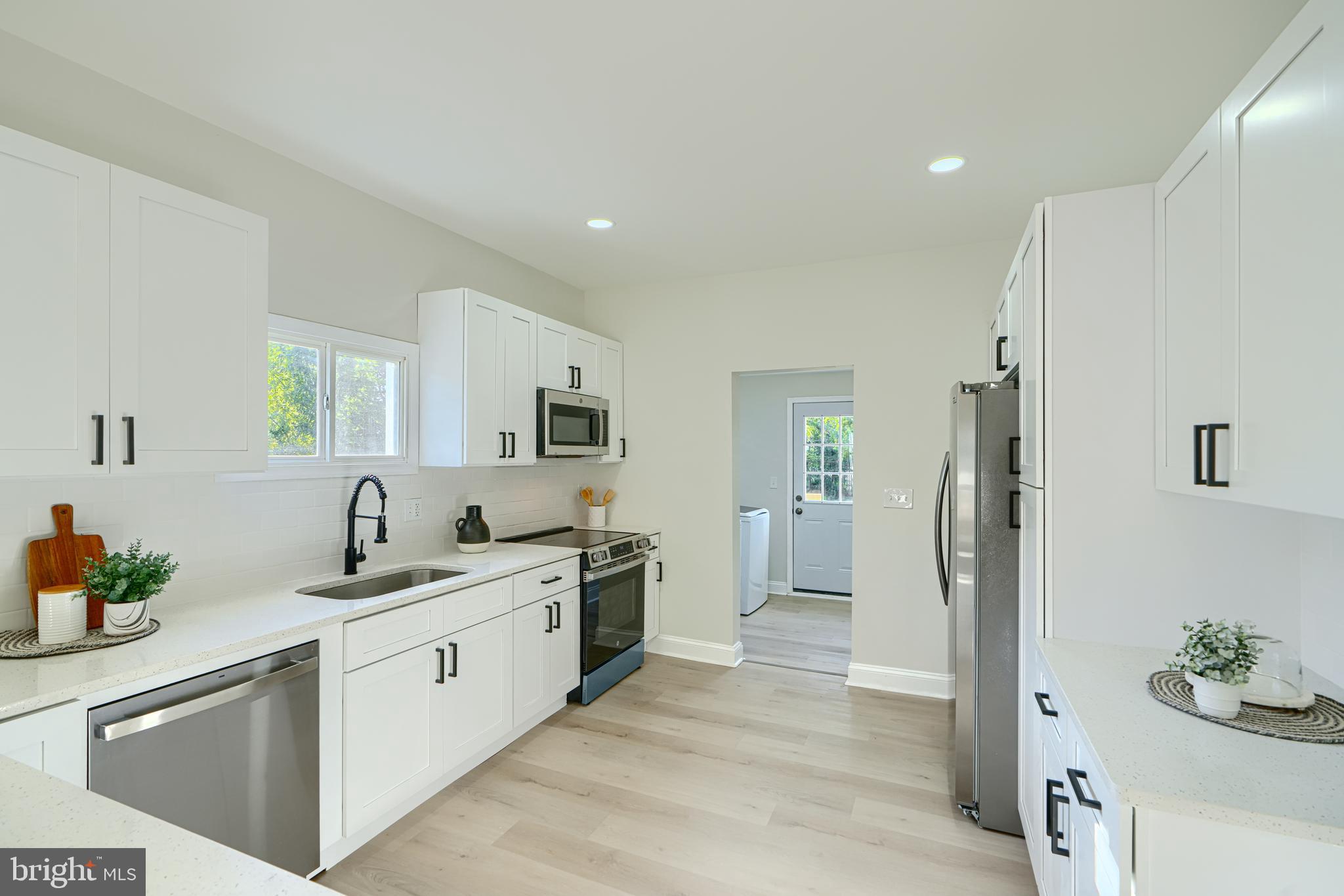2126 Oakland Road Baltimore, MD 21220 - Photo 20 of 53 a kitchen with a sink stove and refrigerator