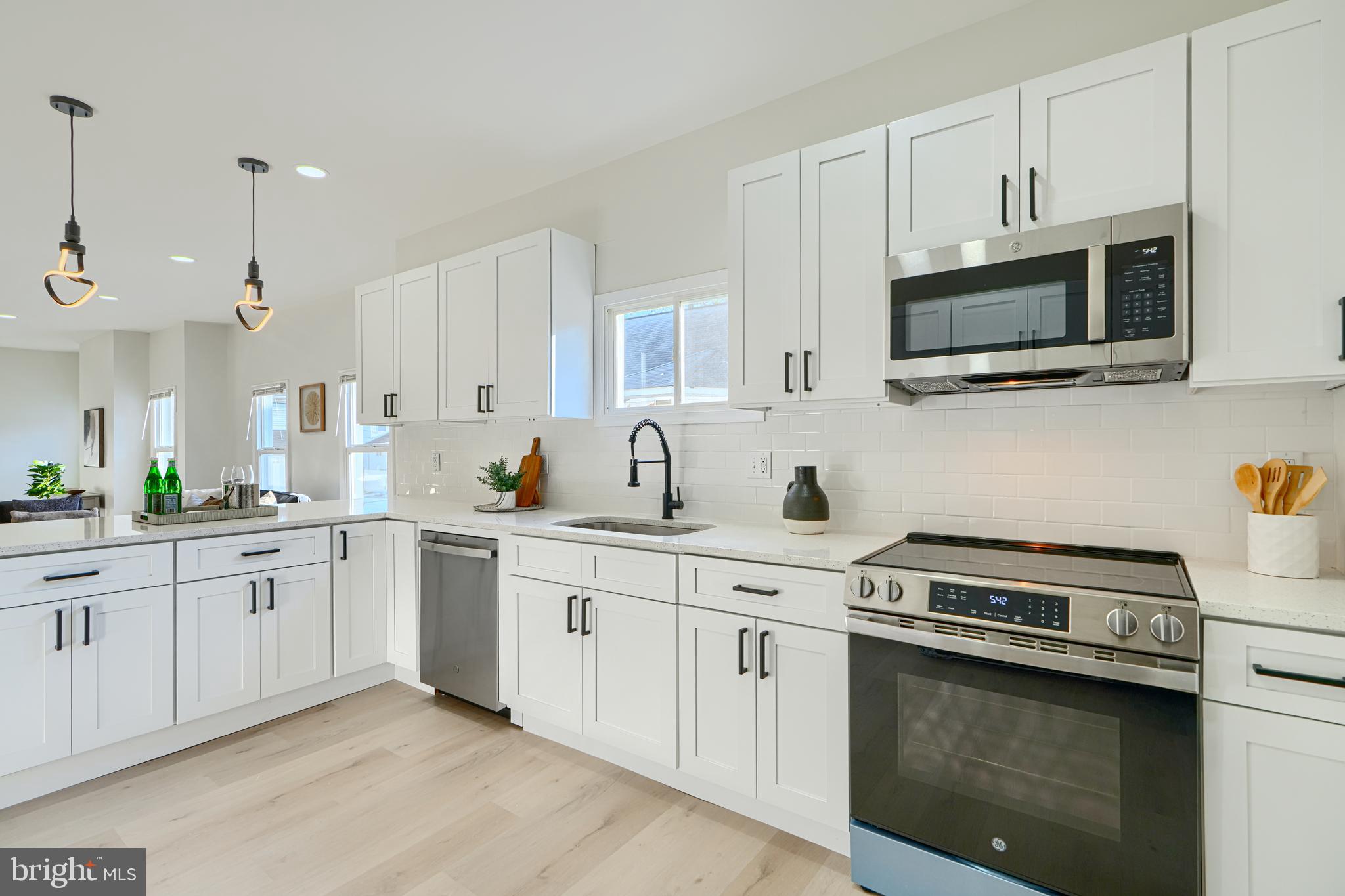 2126 Oakland Road Baltimore, MD 21220 - Photo 21 of 53 a kitchen with stainless steel appliances granite countertop white cabinets a sink and a stove
