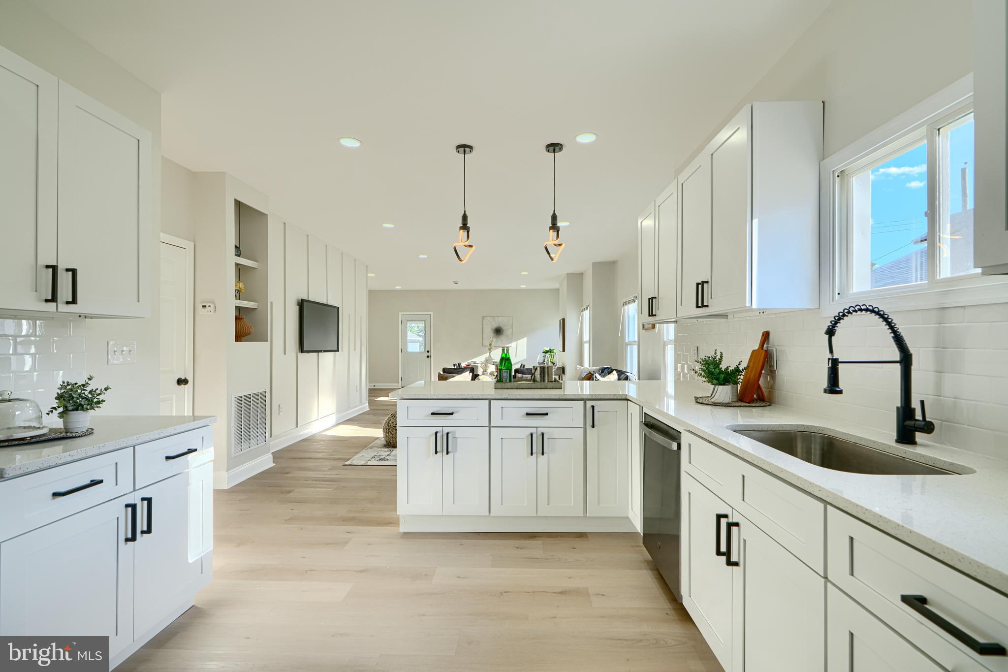 2126 Oakland Road Baltimore, MD 21220 - Photo 22 of 53 a large white kitchen with stainless steel appliances granite countertop a sink and cabinets