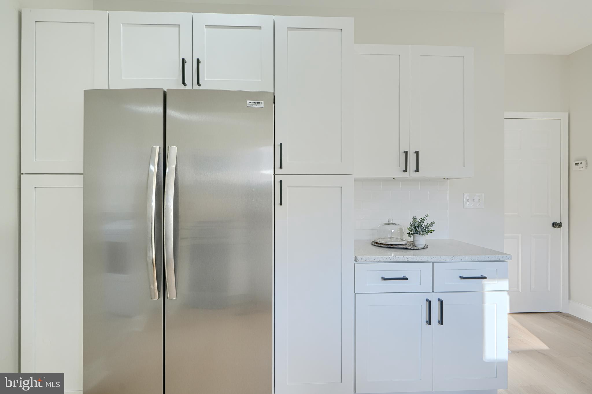 2126 Oakland Road Baltimore, MD 21220 - Photo 24 of 53 a kitchen with cabinets and a refrigerator