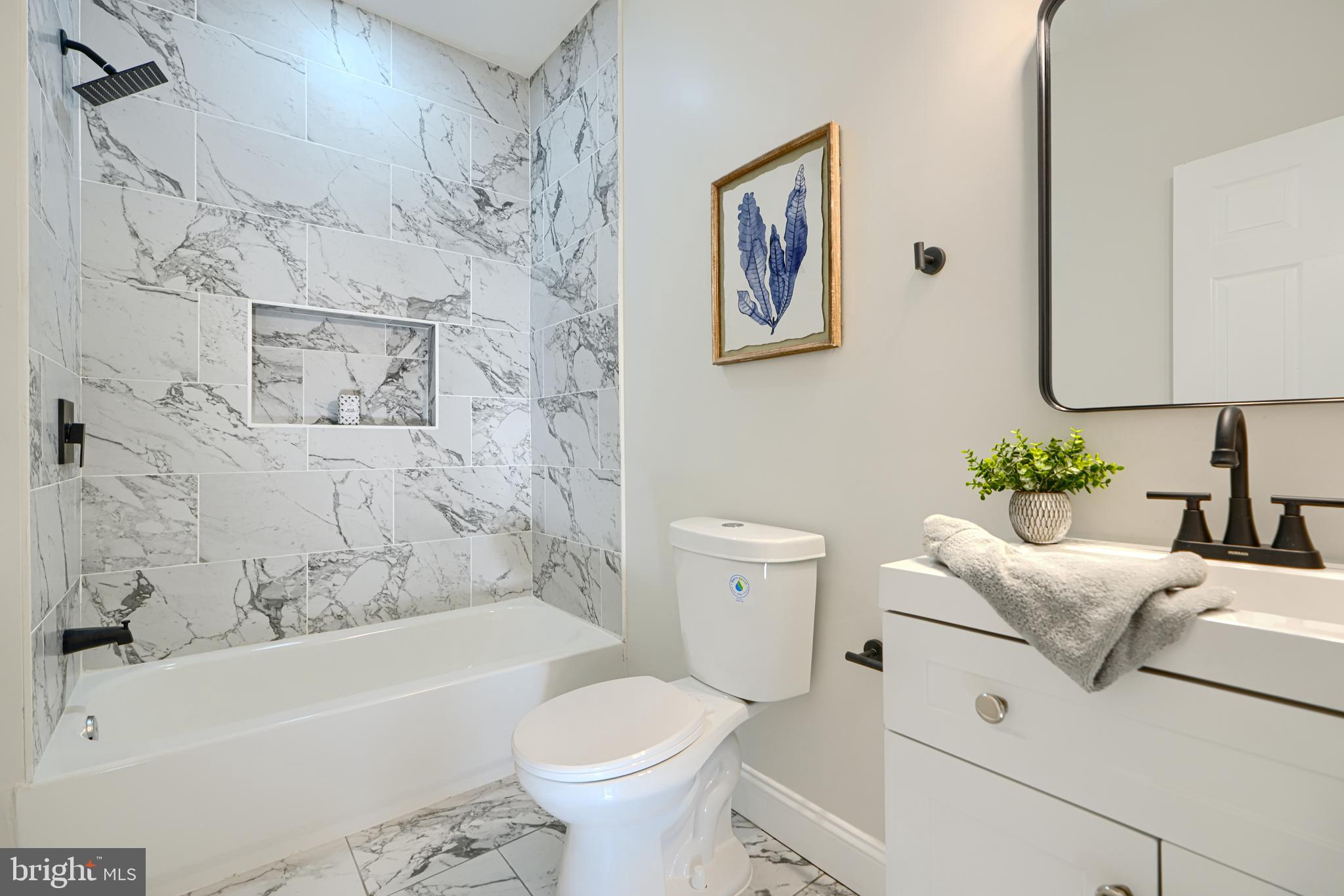 2126 Oakland Road Baltimore, MD 21220 - Photo 32 of 53 a bathroom with a toilet sink and bathtub