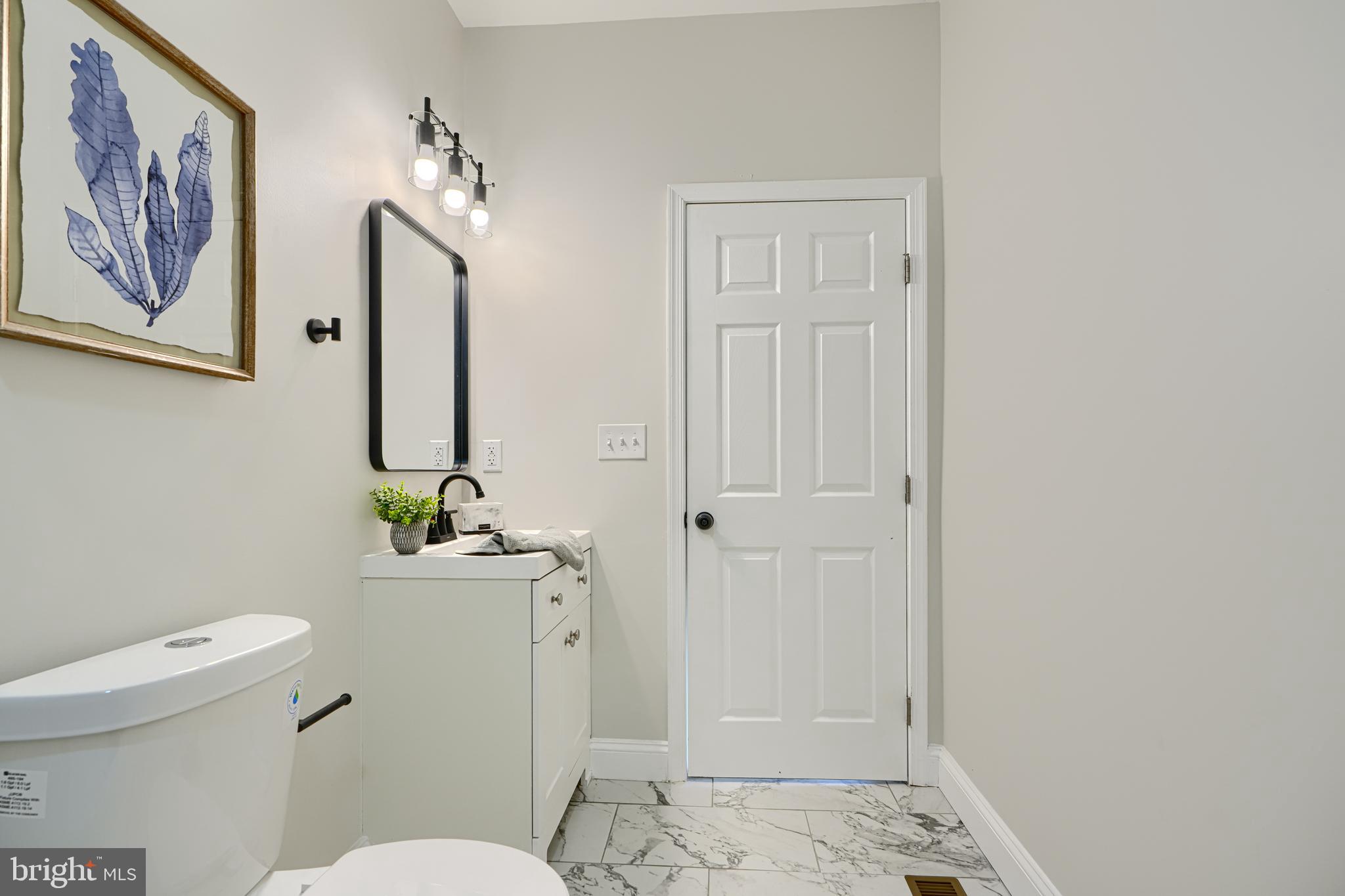 2126 Oakland Road Baltimore, MD 21220 - Photo 34 of 53 a bathroom with a toilet a sink and view of bathroom