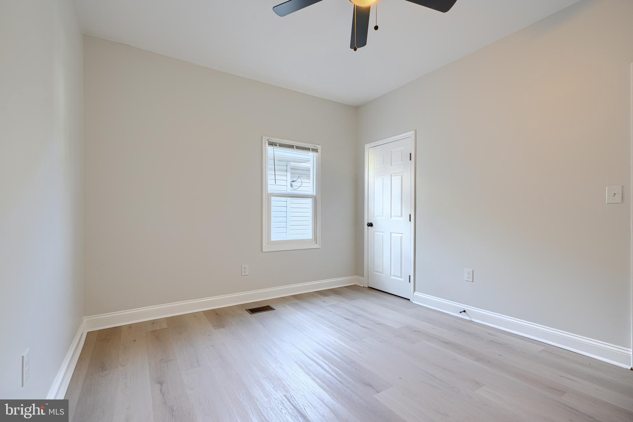 2126 Oakland Road Baltimore, MD 21220 - Photo 42 of 53 an empty room with ceiling fan and window