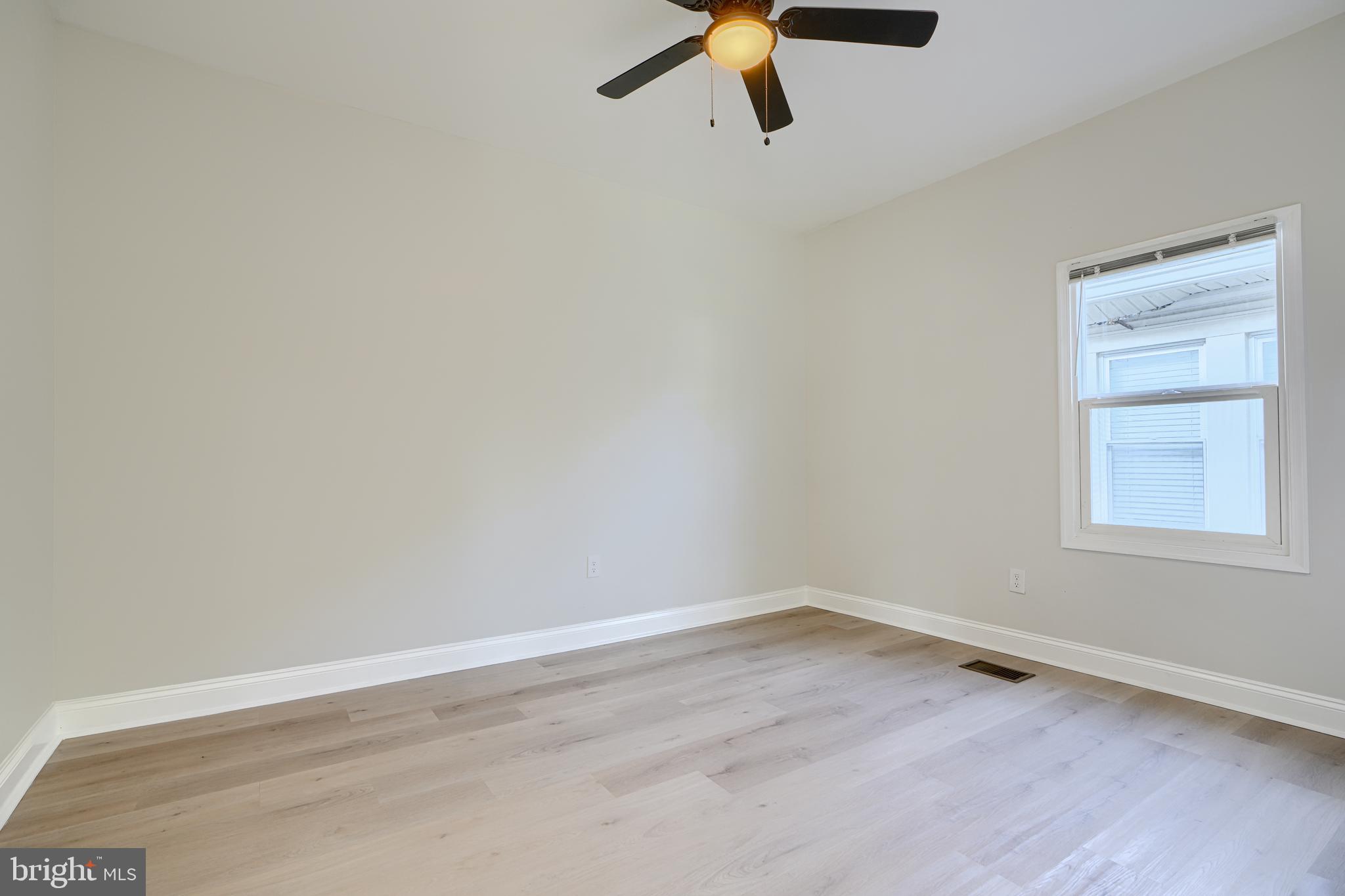 2126 Oakland Road Baltimore, MD 21220 - Photo 44 of 53 a view of a small space with wooden floor and a window