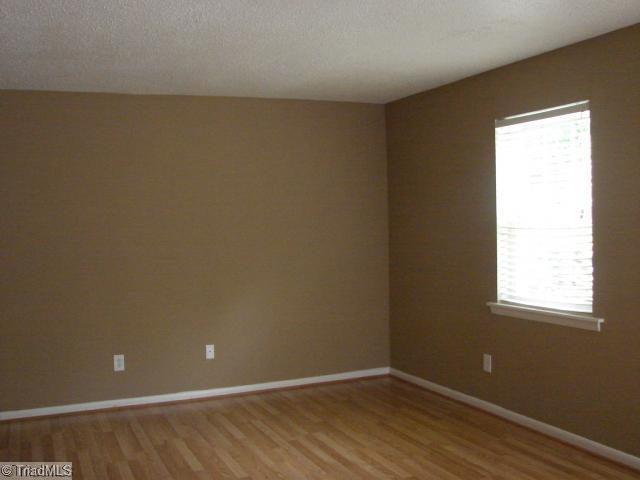5701 M Bramblegate Road Greensboro, NC 27409 - Photo 2 of 9 Living Room. Freshly painted Living Room with new laminate floor.