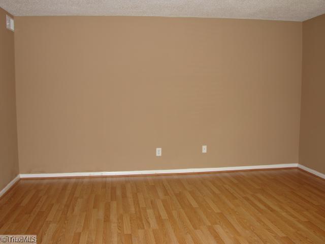 5701 M Bramblegate Road Greensboro, NC 27409 - Photo 3 of 9 Living Room. Another view of Living Room with attractive two-tone paint.