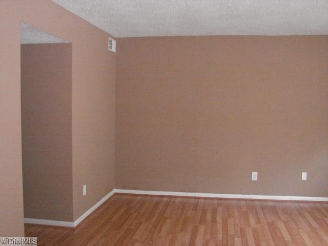 5701 M Bramblegate Road Greensboro, NC 27409 - Photo 4 of 9 Living Room. Spacious Living Room is conveniently adjacent to the Kitchen/ Dining area.