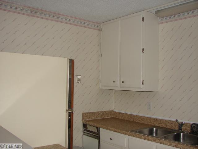 5701 M Bramblegate Road Greensboro, NC 27409 - Photo 6 of 9 Kitchen. Kitchen is equipped with all appliances, new countertop, new flooring.