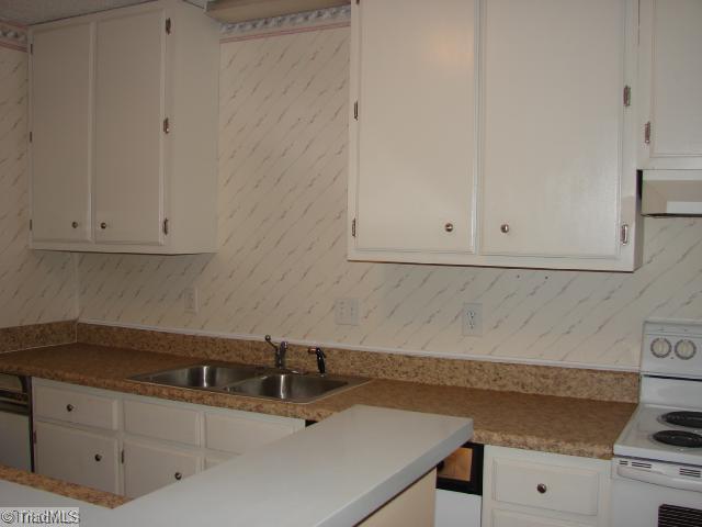 5701 M Bramblegate Road Greensboro, NC 27409 - Photo 7 of 9 Kitchen. The design of this Kitchen provides an additional space for sitting around the Countertop Bar.