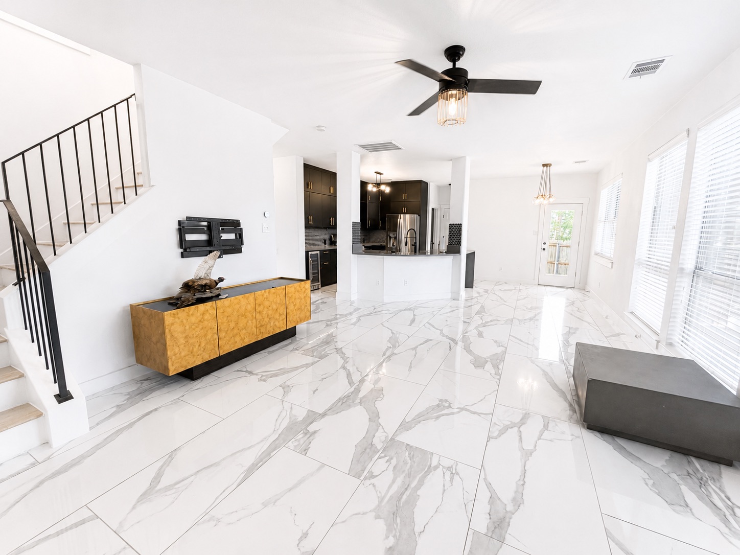 1610 Juniper Ridge Loop Cedar Park, TX 78613 - Photo 8 of 28 Polished stone tile flooring runs throughout this open and airy main-level living space.