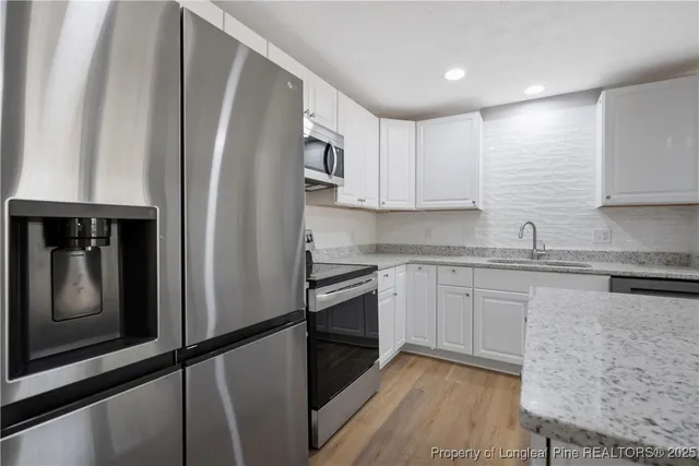 a kitchen with granite countertop stainless steel appliances and wooden cabinets