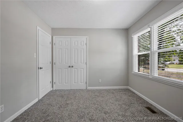 a big room with windows and closet