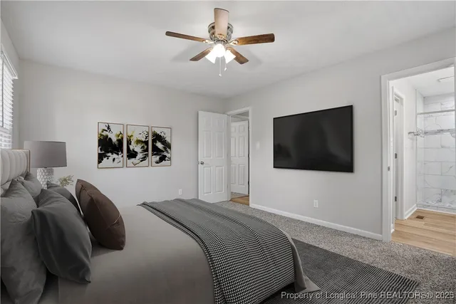 a bedroom with a large bed and a flat screen tv