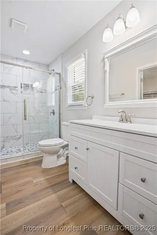 a bathroom with a double vanity sink toilet and shower