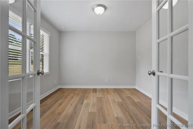 a view of a room with wooden floor and window