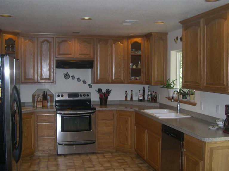 9237 Holland Loop Road Cave Junction, OR 97523 - Photo 6 of 25 a kitchen with stainless steel appliances a sink stove and cabinets