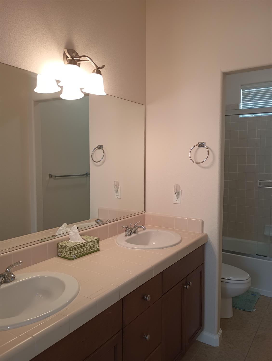 2979 Duncan Avenue Clovis, CA 93611 - Photo 14 of 27 a bathroom with a granite countertop sink and a mirror