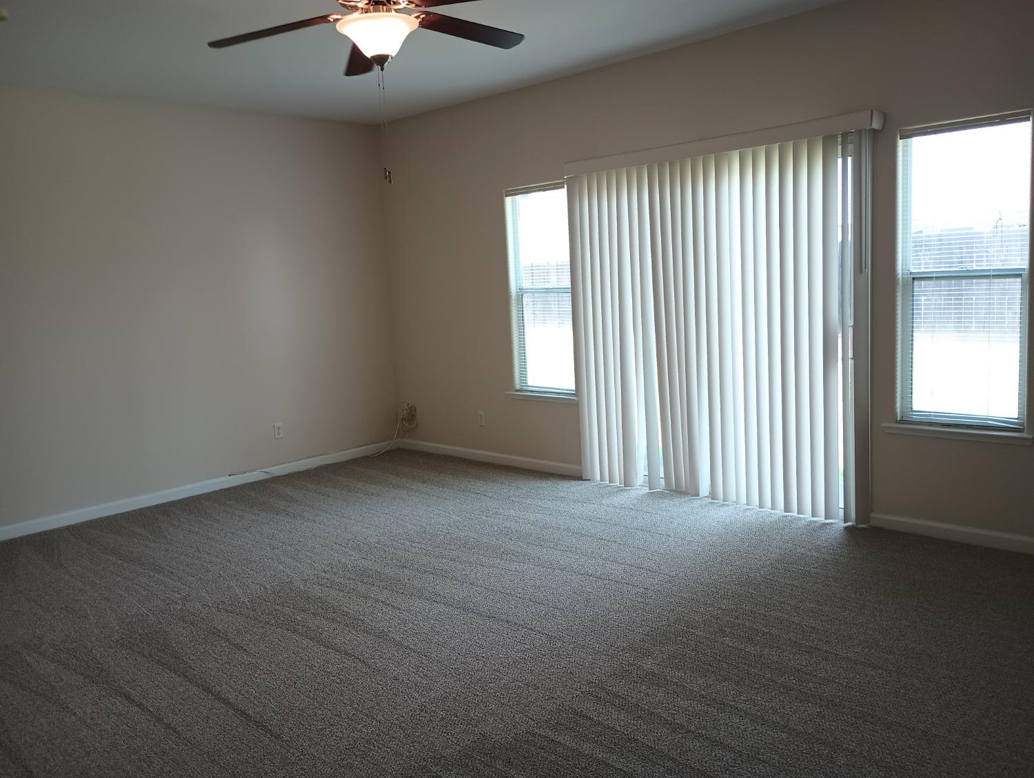 2979 Duncan Avenue Clovis, CA 93611 - Photo 20 of 27 an empty room with a window and a chandelier fan