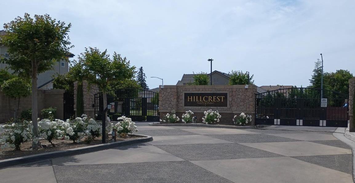 2979 Duncan Avenue Clovis, CA 93611 - Photo 27 of 27 a front view of a house with lots of flowers and trees