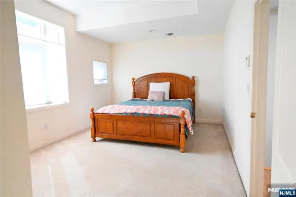 a bed sitting in a bedroom next to a window