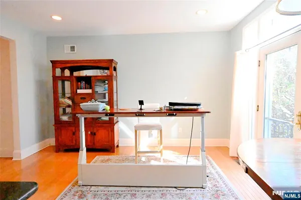 a living room with furniture a rug and a window