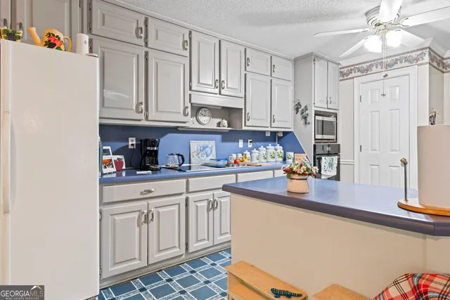 a kitchen with stainless steel appliances granite countertop a refrigerator sink and cabinets