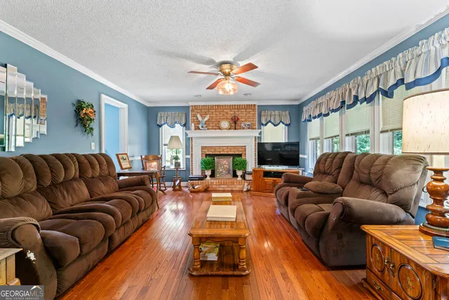 a living room with furniture fireplace and flat screen tv