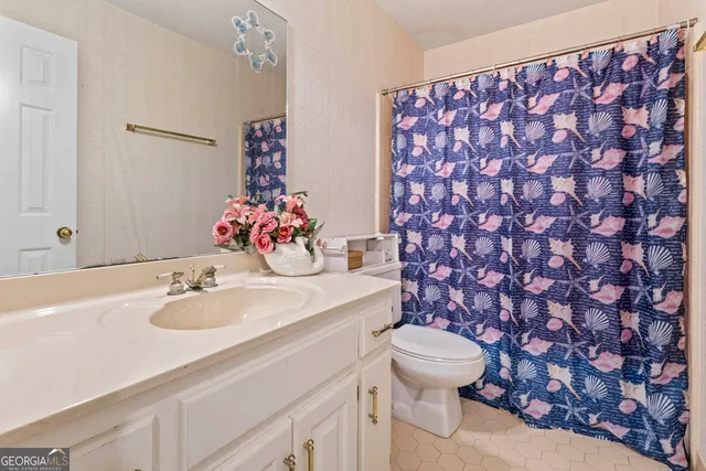 a bathroom with a sink mirror vanity and toilet