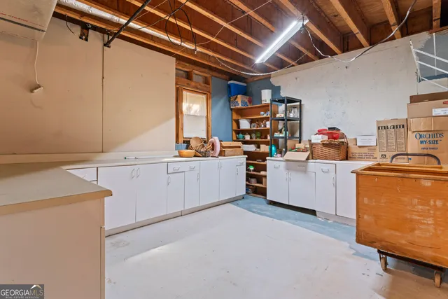 a utility room with cabinets dryer and washer