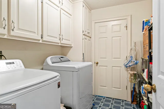 a view of storage and utility room with washer and dryer
