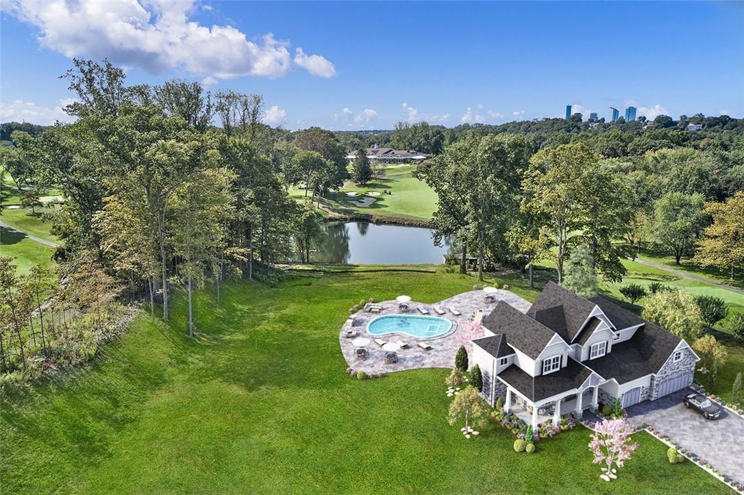an aerial view of a house with garden space ocean and mountain view in back