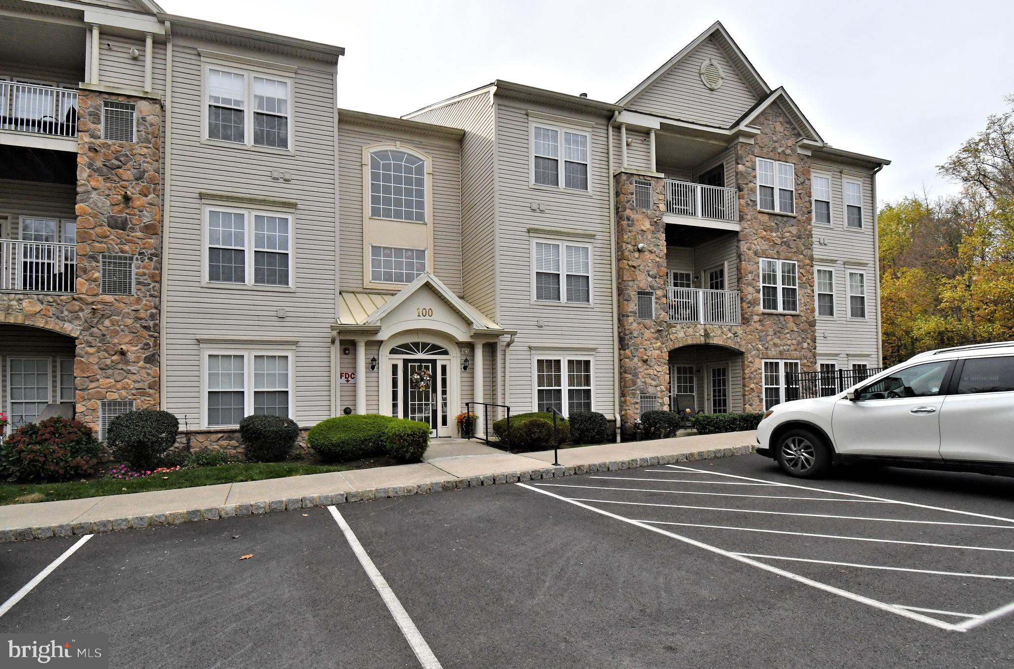 100 Ginko Street, Unit 202 Warrington, PA 18976 - Photo 1 of 53 a view of a white apartments with large windows
