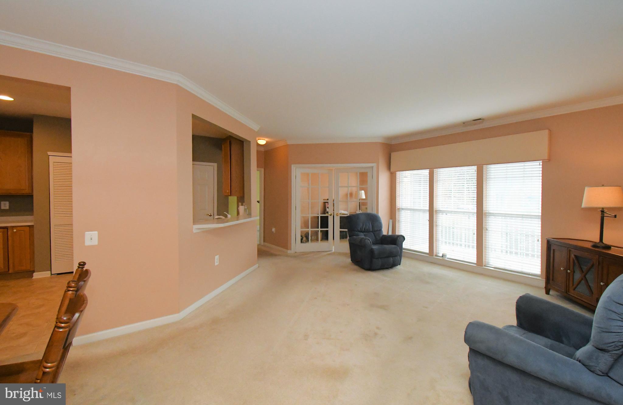 100 Ginko Street, Unit 202 Warrington, PA 18976 - Photo 15 of 53 a spacious bedroom with furniture and a large window