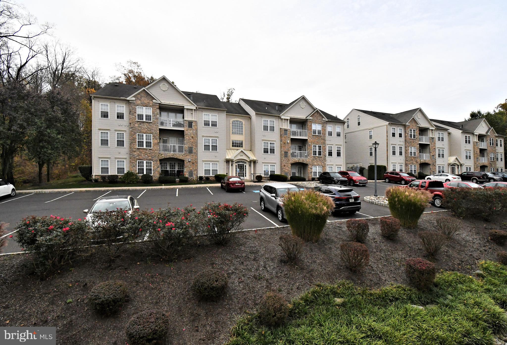 100 Ginko Street, Unit 202 Warrington, PA 18976 - Photo 2 of 53 a view of a street with cars parked