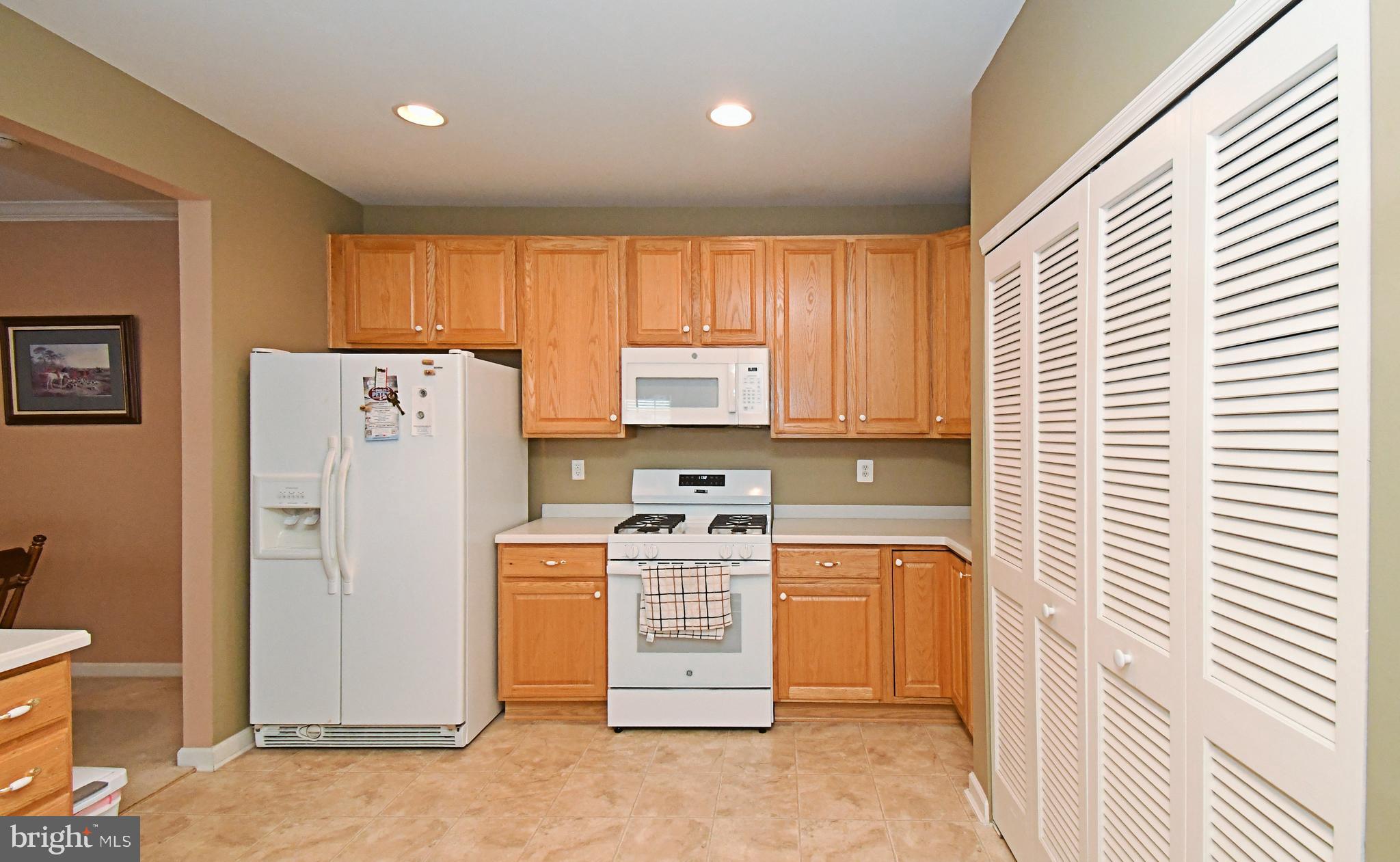 100 Ginko Street, Unit 202 Warrington, PA 18976 - Photo 25 of 53 a kitchen with a stove a refrigerator and a window