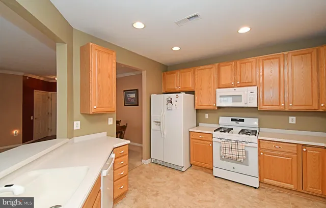 a kitchen with a refrigerator and a sink