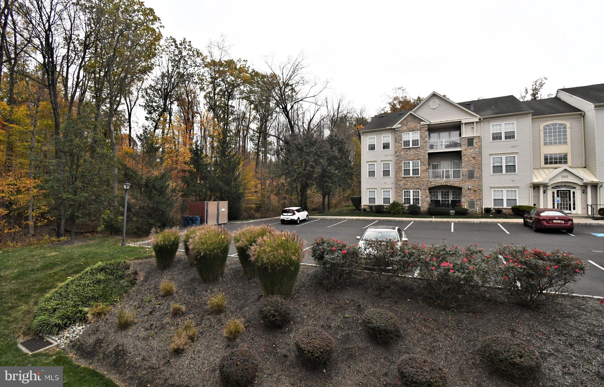 100 Ginko Street, Unit 202 Warrington, PA 18976 - Photo 3 of 53 a view of a street with cars