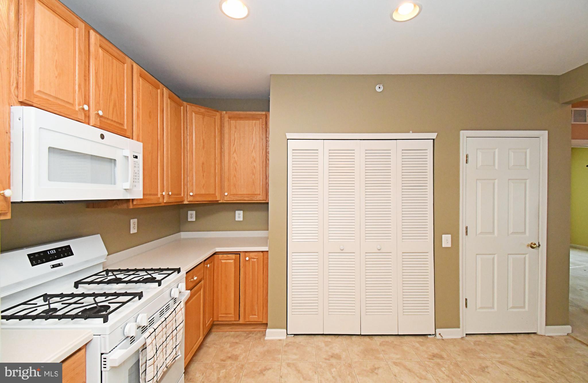 100 Ginko Street, Unit 202 Warrington, PA 18976 - Photo 31 of 53 a kitchen with a stove a sink and a microwave