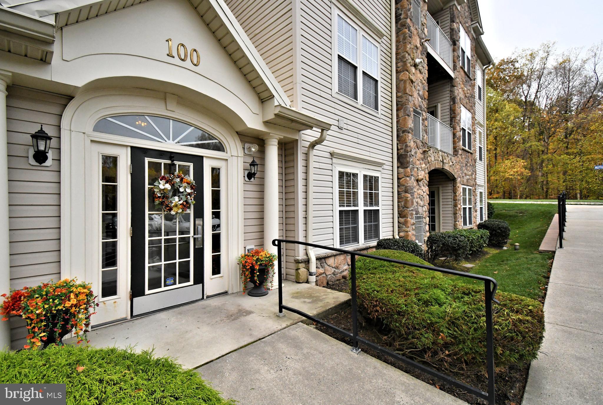 100 Ginko Street, Unit 202 Warrington, PA 18976 - Photo 6 of 53 a front view of a house with outdoor seating