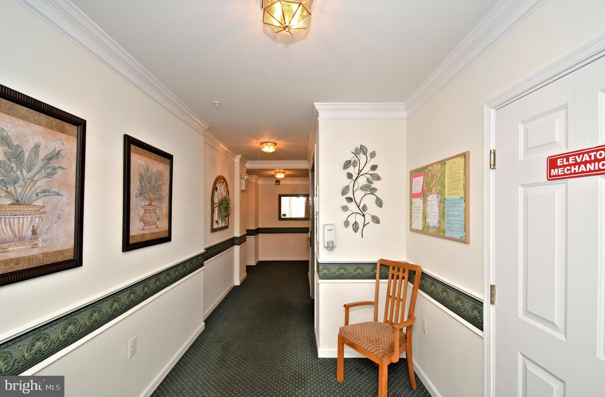 100 Ginko Street, Unit 202 Warrington, PA 18976 - Photo 9 of 53 a hallway with a large mirror on a couches with wooden floor
