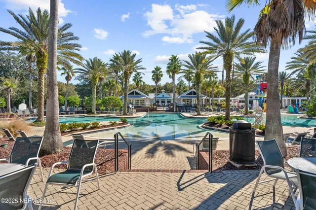 a view of a swimming pool and lounge chairs
